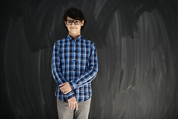 Image showing portrait  of smart looking arab teenager with glasses against bl