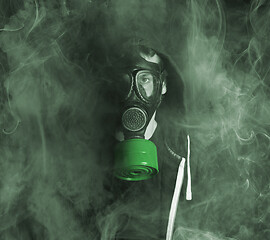 Image showing Man in a gas mask in the smoke