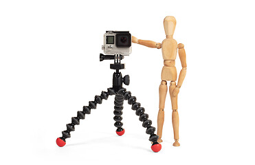 Image showing Wooden dummy standing trying to make a video or photo