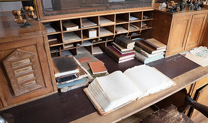 Image showing Very old desk, full of old books and old paper