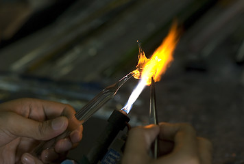 Image showing Artist shaping glass