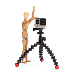 Image showing Wooden dummy standing trying to make a video or photo