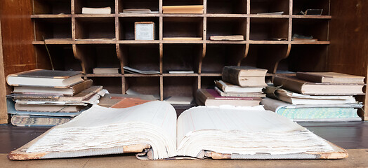 Image showing Very old desk, full of old books and old paper