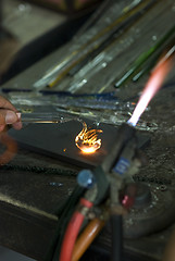 Image showing Artist shaping glass