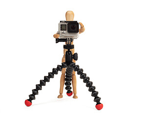 Image showing Wooden dummy standing trying to make a video or photo