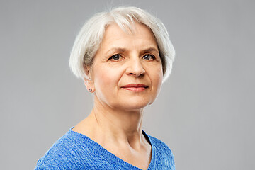 Image showing portrait of senior woman in blue sweater over grey