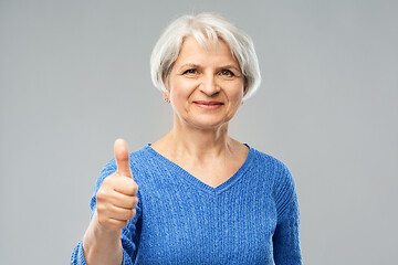 Image showing smiling senior woman r showing thumbs up