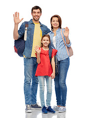 Image showing happy family with backpacks waving hands
