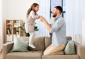 Image showing father and daughter jumping and having fun at home