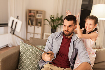 Image showing father and daughter taking selfie at home