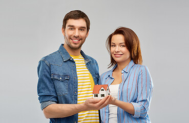 Image showing smiling couple holding house model