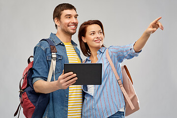 Image showing happy couple of tourists with tablet computer