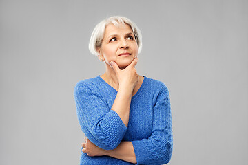 Image showing portrait of senior woman in blue sweater thinking