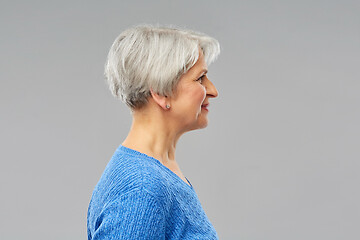 Image showing portrait of senior woman in blue sweater over grey