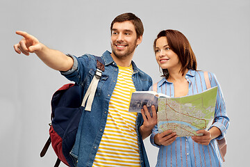 Image showing happy couple of tourists with city guide and map