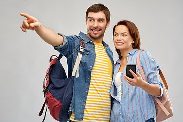 Image showing happy couple of tourists with smartphone