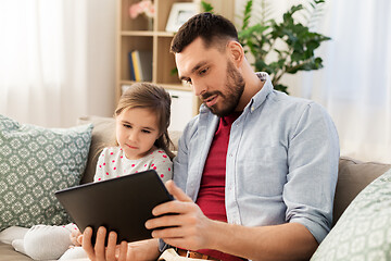 Image showing father and daughter with tablet computer at home