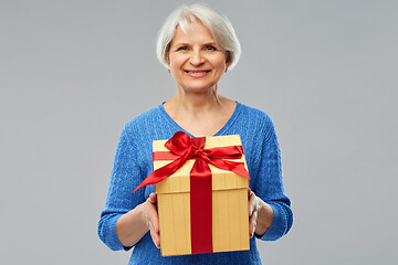 Image showing happy smiling senior woman with gift box