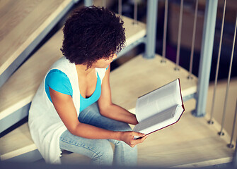 Image showing african student girl reading book at library