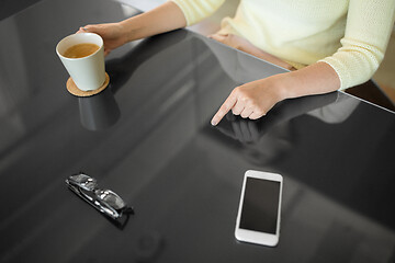 Image showing woman with coffee using black interactive panel