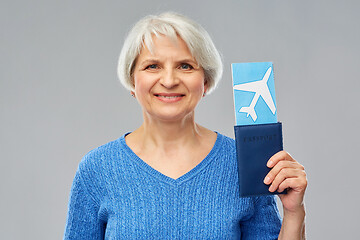 Image showing senior woman with passport and airplane ticket