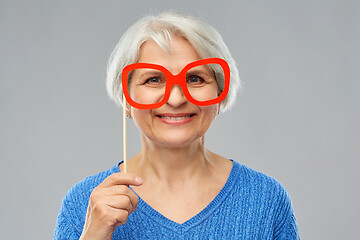 Image showing funny senior woman with big party glasses