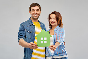 Image showing smiling couple holding green paper house