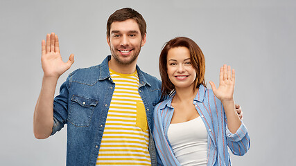 Image showing happy couple waving hands