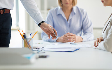 Image showing business team discussing papers at office