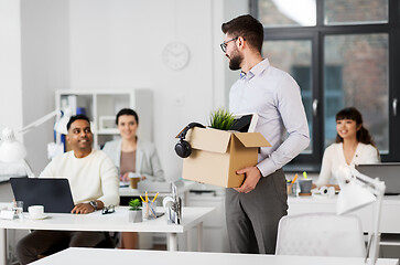 Image showing happy male office worker with personal stuff