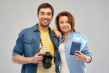 Image showing happy couple with air tickets, passport and camera