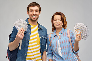 Image showing couple of tourists with backpacks and money