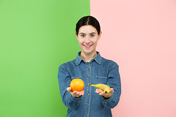 Image showing Beautiful close-up portrait of young woman with fruits. Healthy food concept.