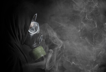 Image showing Man in a gas mask in the smoke