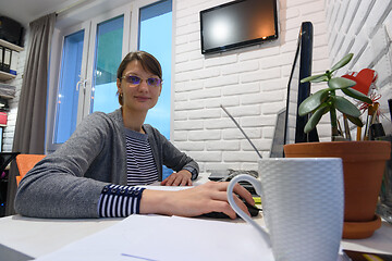 Image showing Girl works at the computer remotely at home