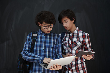 Image showing Arab teenagers group working on laptop and tablet computer