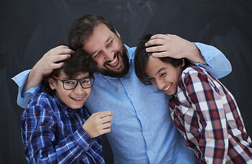 Image showing happy father hugging sons