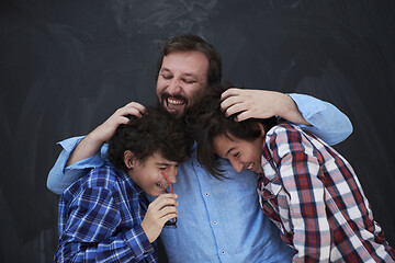 Image showing happy father hugging sons