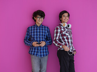 Image showing Arab teenagers  against pink wall