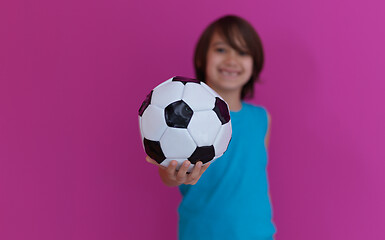 Image showing Arabic boy with soccer ball against  pink background