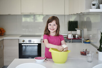 Image showing Mother and daughter playing and preparing dough in the kitchen.