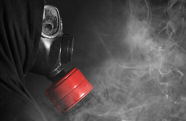Image showing Man in a gas mask in the smoke