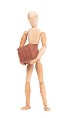 Image showing Wooden mannequin carrying a wooden hardwood block