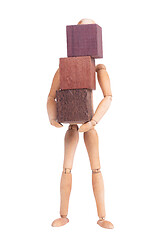 Image showing Wooden mannequin carrying wooden hardwood blocks