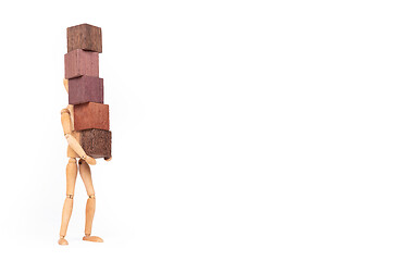 Image showing Wooden mannequin carrying wooden hardwood blocks