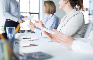 Image showing people applauding to colleague at office meeting