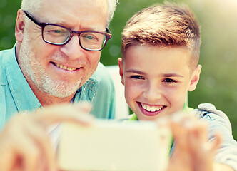 Image showing old man and boy taking selfie by smartphone