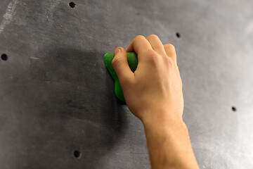 Image showing male hand holding to indoor climbing wall