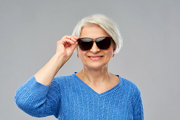 Image showing smiling senior woman in black sunglasses