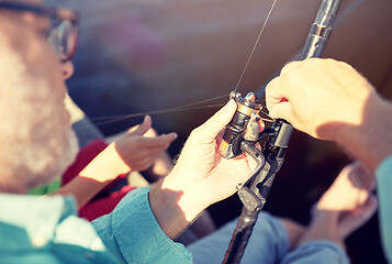 Image showing senior man with fishing rod or spinning on river